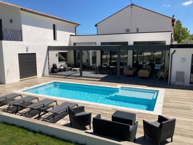 piscine coque rectangulaire avec margelles et terrasse planchées